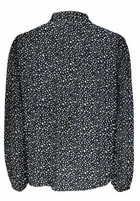 Marineblauw shirt met lange mouwen, voorzien van een verspreid patroon van witte, onregelmatige stippen, met een hoge kraag en elastische manchetten.