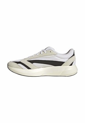 Scarpa da ginnastica bianca e beige con strisce laterali nere, tomaia in mesh, suola imbottita e lacci bianchi, mostrata in profilo laterale destro su sfondo bianco.
