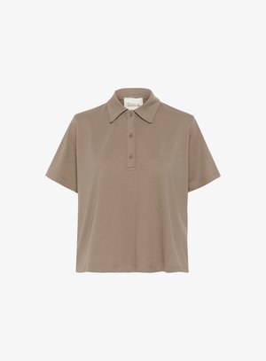 Short-sleeved polo shirt in light brown cotton. Features a classic collar, three buttons, and a loose fit. Smooth texture with minimal detailing.