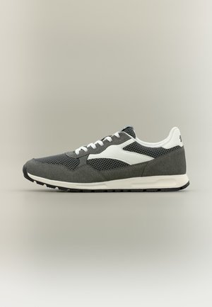 Gray and white athletic sneaker with mesh and suede panels, white laces, and black sole on a neutral background.