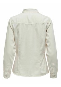 Veste en denim à manches longues couleur blanc cassé vue de dos, avec poignets boutonnés et empiècements cousus aux épaules.