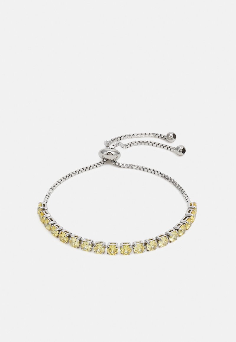 Bracelet en argent réglable avec une rangée de pierres précieuses jaunes et un fermoir coulissant avec deux petites perles en argent aux extrémités.