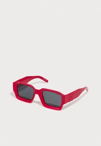 Red rectangular sunglasses with dark lenses and "HUGO" embossed on the temple, set against a plain white background.
