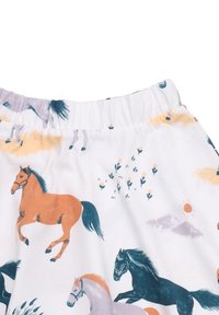 Weißer Stoff mit einem bunten Pferde-Druck, der braune, graue und schwarze Pferde, Blumen und leichte Pompons entlang des elastischen Taillengummis zeigt.