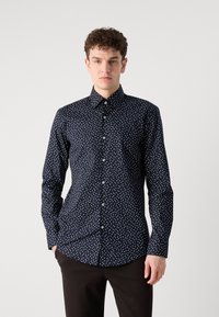 Marineblå skjorte med hvite prikkene, klassisk krage, tettsittende design, lange ermer og frontlukkning med knapper. Glatt bomullsstoff.
