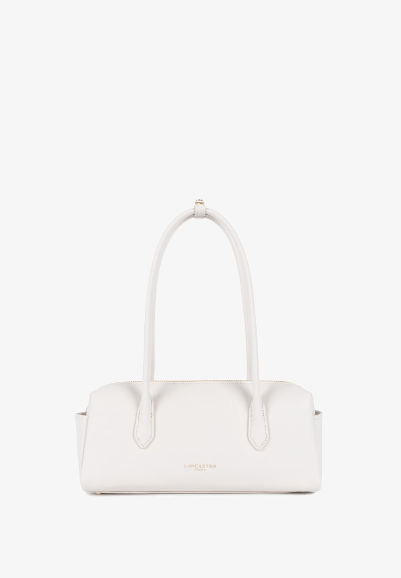 Sac à main Lancaster Paris en cuir blanc avec longues poignées doubles et fermeture éclair dorée sur le dessus, forme rectangulaire au design minimaliste.