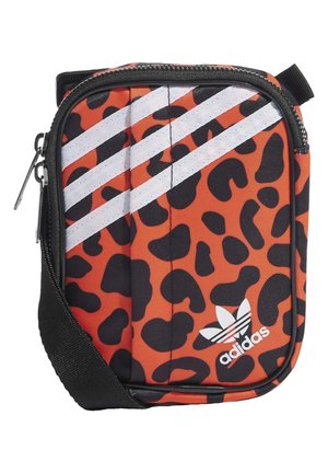 Orange and black leopard print crossbody bag with white Adidas logo and three diagonal white stripes, black zipper, and adjustable black strap.