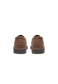 Bruine leren schoenen met een gladde afwerking, voorzien van een verhoogde hak, gestructureerde zijkanten en contrasterende stikdetails. De zool heeft een profielpatroon.