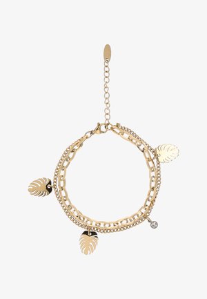 Dubbele armband in goudkleur met drie bladerenvormige bedels en één kleine heldere kristalbedel, bevestigd met een karabijnsluiting en verstelbare ketting.