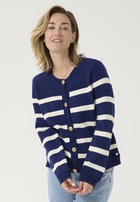 Navy blue cardigan with white horizontal stripes, round neckline, and five gold-tone buttons. Ribbed cuffs and hem add texture.