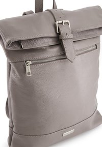 Gray leather backpack with a rolled top, adjustable straps, front zip pocket, and textured surface. Includes silver hardware accents.