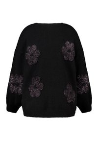 Pull noir à la coupe loose, avec des appliqués floraux texturés en violet à l'avant. Tissu doux, encolure ronde et manches larges.