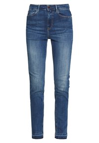 Blå denimjeans med smal passform, femficksdesign och en urtvättad effekt på låren. Har en knapp- och dragkedjestängning.