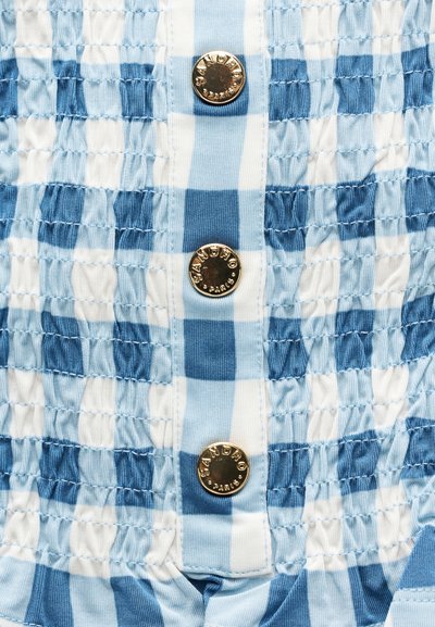 Υφασμα σε ανοιχτό γαλάζιο και λευκό καρό με ρυτιδωτή υφή, διακοσμημένο με τρία λαμπερά χρυσά κουμπιά χαραγμένα με το "Sandro Paris".