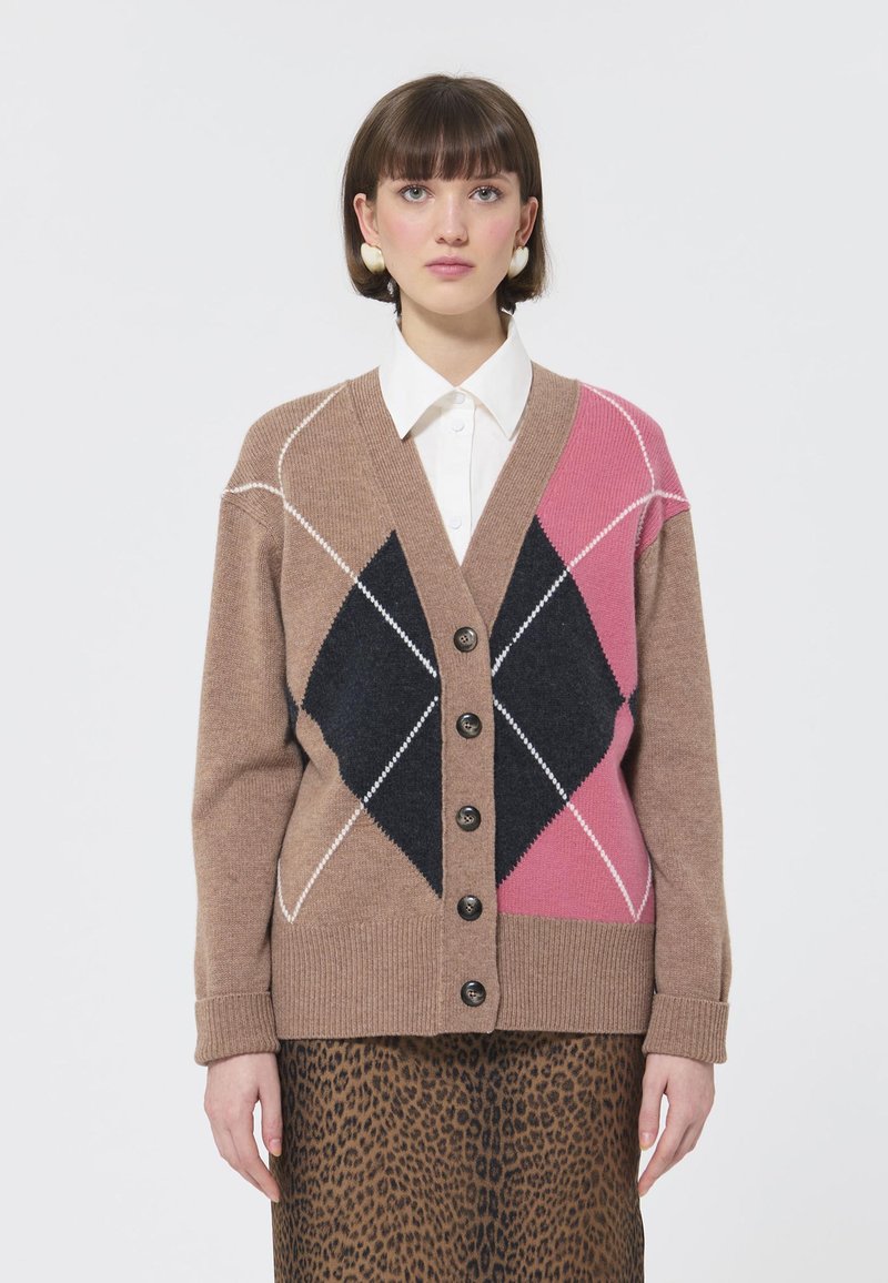 Cardigan maro cu un model argyle în nuanțe de crem, roz și negru. Prezintă un decolteu în V, cinci butoni și manșete cu model ondulat. Purtați peste o fustă cu imprimeu leopard.
