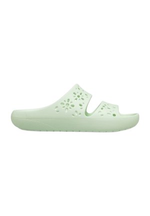 Sandalo slip-on verde chiaro con due cinturini aperti e fori di ventilazione a forma di fiore sulla parte superiore.