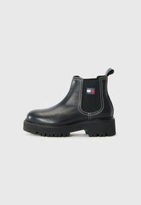 Bottines Chelsea noires en cuir, avec des panneaux lat�éraux en élasthanne, des coutures blanches contrastées et une semelle en caoutchouc texturée.
