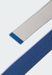 Dos correas textiles: una gris claro con una punta de plástico azul y otra azul oscuro sólida. Ambas tienen una textura tejida y forma rectangular.