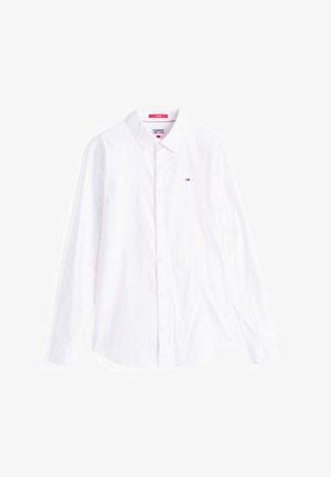 Chemise blanche à manches longues en coton, dotée d'une fermeture à boutons à l'avant, d'un col pointu et d'un petit logo sur la poitrine. Texture lisse.