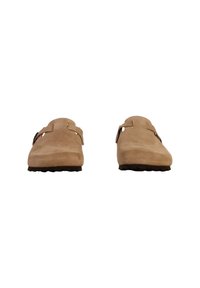 Beige suede clogs with a smooth, matte finish, featuring two adjustable straps and a contoured footbed. Designed with a wide toe box and textured sole.
