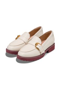 Cream-colored loafers with a glossy finish, gold hardware detail, and a maroon rubber sole featuring a textured pattern.