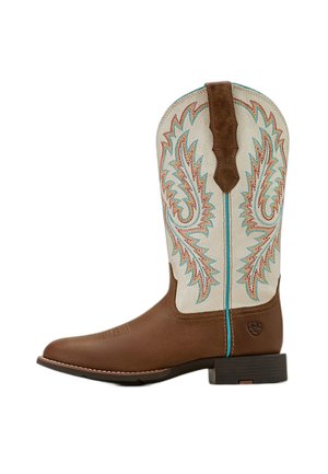 Botte de cowboy en cuir marron avec tige supérieure blanche présentant des coutures décoratives bleues et orange et un talon bas empilé.
