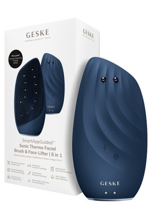 Donkerblauwe elektrische sonische gezichtsborstel naast de witte doos, merk Geske, met een getextureerd siliconen oppervlak en bedieningsknoppen.