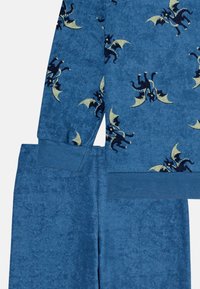 Blue, plush fabric loungewear set featuring a dragon pattern in navy and yellow. Includes a long-sleeve top and matching pants with cuffs.