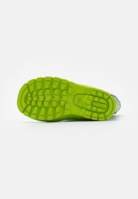 Semelle de chaussure en caoutchouc vert avec un motif de semelle texturé, présentant des bords arrondis et un marquage de la marque. Design épuré sans signes d'usure visible.