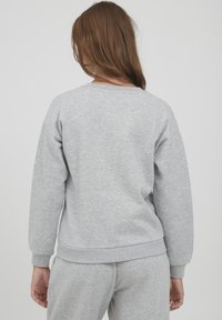 Sweatshirt en coton gris à manches longues, encolure ras du cou, et bords-côtes aux poignets et à l'ourlet. Texture douce avec une coupe décontractée.