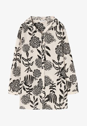 Chemise à capuche en tissu naturel présentant un motif floral noir. Devant à boutons avec des manches longues et une coupe décontractée.