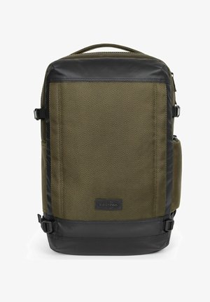Green textured fabric backpack with black synthetic accents, adjustable straps, side pocket, and front logo patch. Rectangular design.