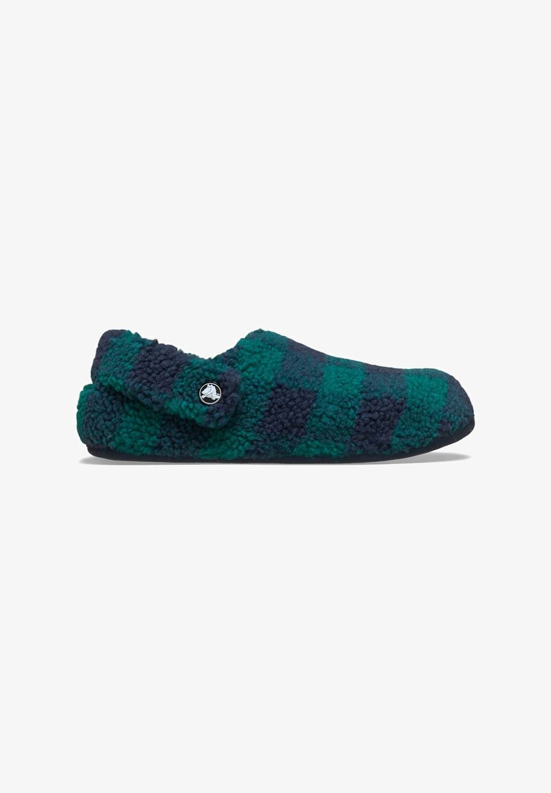 Fuzzy instapsloffen in een groen en marineblauw ruitpatroon, met een ronde neus, zachte textuur en een knoopaccent aan de zijkant.