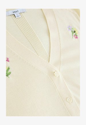 Cremefarbener Cardigan mit V-Ausschnitt, verziert mit floralen Stickereien in Rosa, Gelb und Grün. Weicher Stoff; mit Knopfverschluss und gerippten Details.