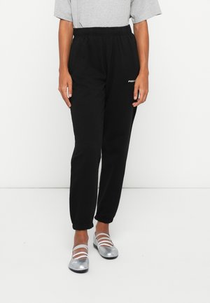 Black jogger pants with an elastic waistband, cuffed hems, and a side pocket featuring a small white logo. Made from soft fabric.