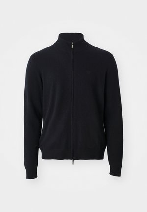 Black full-zip sweater with high collar, long sleeves, and subtle logo on the left chest, displayed on a white background.