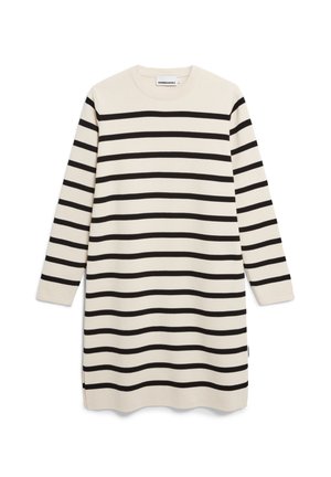 Gestreiftes Kleid in Creme und Schwarz, aus weichem Stoff gefertigt. Lange Ärmel, Rundhalsausschnitt, knielang, mit seitlichen Schlitzen für eine bessere Bewegungsfreiheit.