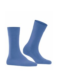 Chaussettes bleues en matériau lisse et extensible. Elles présentent une couleur unie avec une longueur mi-mollet et un design de bord en côtes.