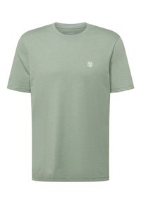 Camiseta de manga corta verde claro con cuello redondo y pequeño logo circular blanco en el lado izquierdo del pecho.