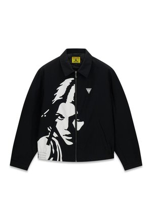 Veste noire zippée avec un graphisme blanc du visage d'une femme sur le devant et un petit logo triangulaire sur la poitrine.