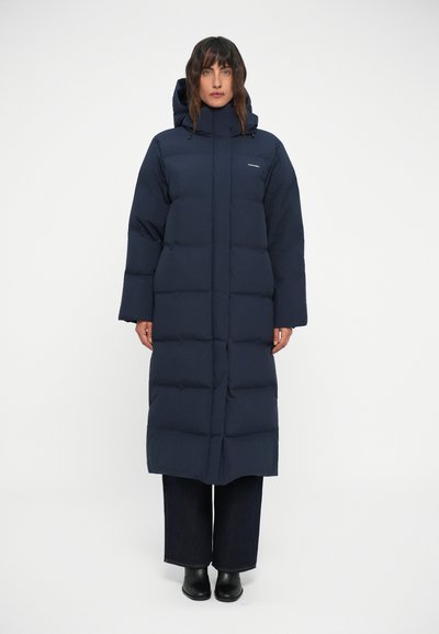 Manteau long matelassé bleu marine avec capuche, présentant un design matelassé, des manches larges et une silhouette droite, fabriqué à partir d'un matériau lisse.