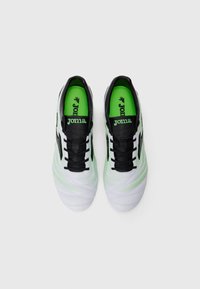 White and green athletic shoes with a textured upper, black accents, and a smooth sole. Features a logo on the tongue and laces.
