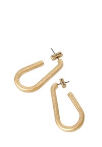 Gold-tone hoop earrings with a curved design and a textured finish. Feature a flat top with engraved branding and a straight post.