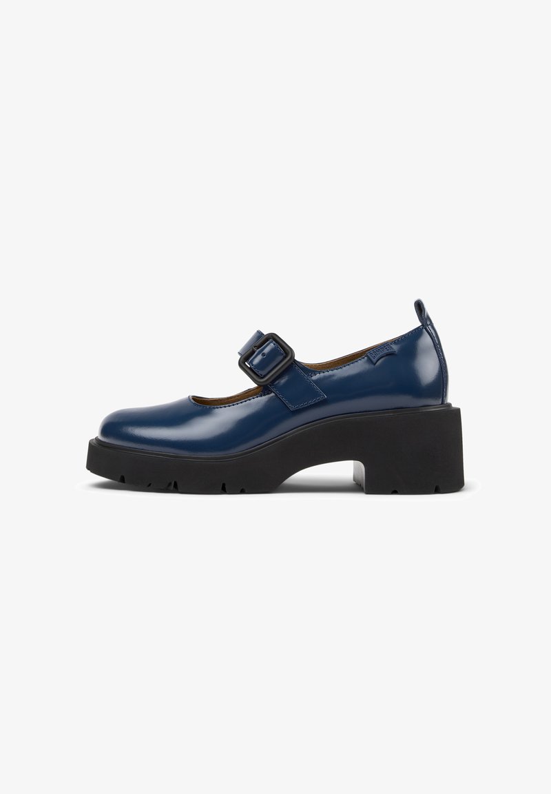 Navy blue patent leather Mary Jane shoes with a square toe, adjustable buckle closure, and chunky black platform sole.
