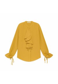Blusa a maniche lunghe di colore giallo senape con scollo rotondo, volant sul davanti e polsini arricciati con lacci per una vestibilità regolabile. Tessuto dalla texture liscia.