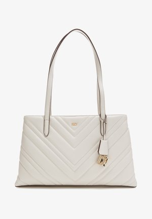 Cream quilted leather handbag with chevron pattern, double shoulder straps, and gold DKNY logo charm hanging from one strap.