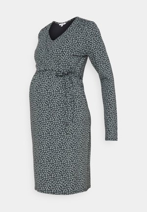 Pitkähihainen äitiysmekko, jossa pieni valkoinen kukkakuvio tummalla pohjalla, istutettu vyötärö sivusolmulla, polvenpituinen malli.