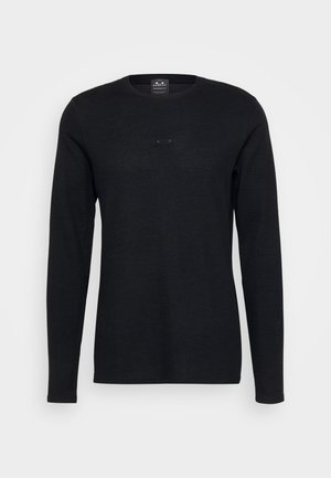 Černé dlouhé rukávy triko vyrobené z texturované látky. Má kulatý výstřih a decentní logo na hrudi. Jednoduchý design, bez vzorů.