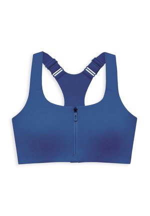 Brassière de sport bleue avec larges bretelles, fermeture éclair à l'avant et matière lisse et extensible. Présente des accents contrastants sur les bretelles.