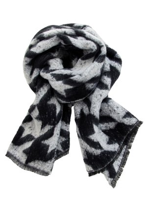 Soft wool scarf with black and white abstract pattern, loosely folded with fringed edges visible.